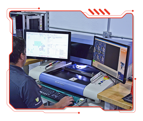 A technician reviewing a scanned board on the automated optical inspection machine